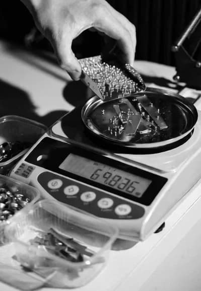Gold pieces being weighed on a precision scale at the APM Castings workshop